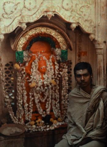 A Hindu priest sits in front of his temple - 1923