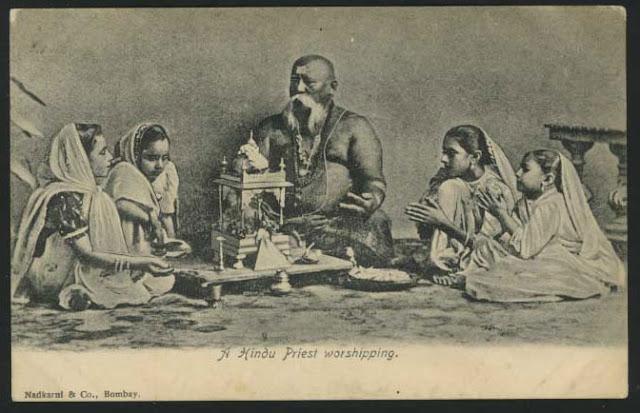 A Hindu Priest Worshipping God with Girls