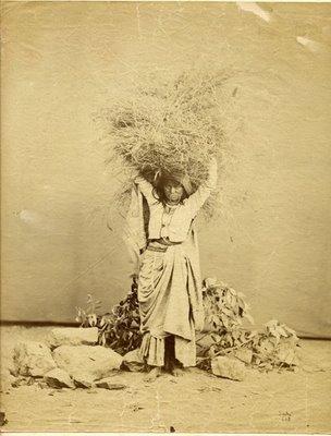 A Woman Carrying Wheat - 1880s