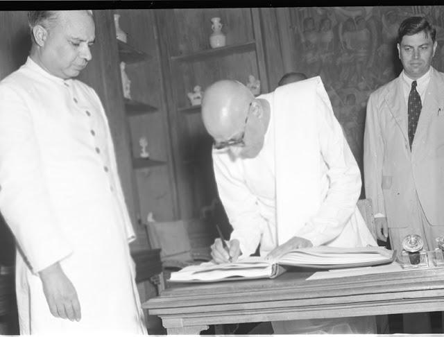 C. Rajagopalachari signing the register after he had taken his oath of office as a Cabinet Minister at a Government House ceremony on July 15, 1950