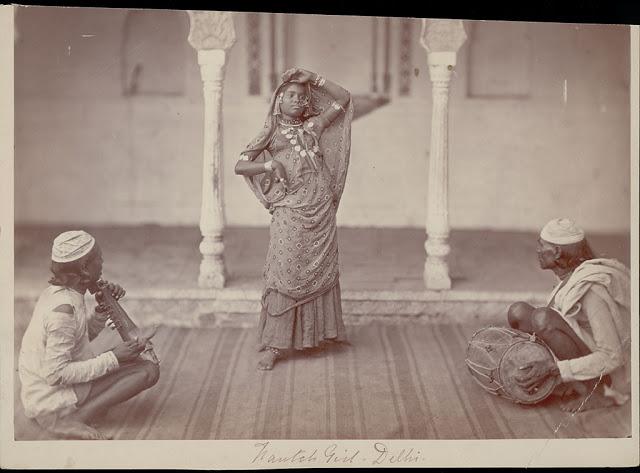 Nautch Girl Dancing in Costume with Ornaments - Two Men Playing String Instrument and Drum Nearby - Charles Shepherd - 1862